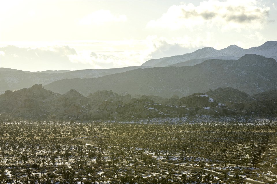 Snow over the Barker Dam parking area near sunset photo