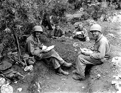 SC 396939 - Four infantrymen read mail received during the fighting on Saipan. photo