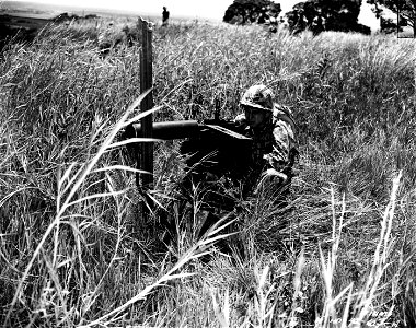 SC 151476 - Pvt. Julius A. Ziolo, Co. H, 35th Inf., demonstrates the effectiveness of new type camouflage uniform during 25th Division problems.