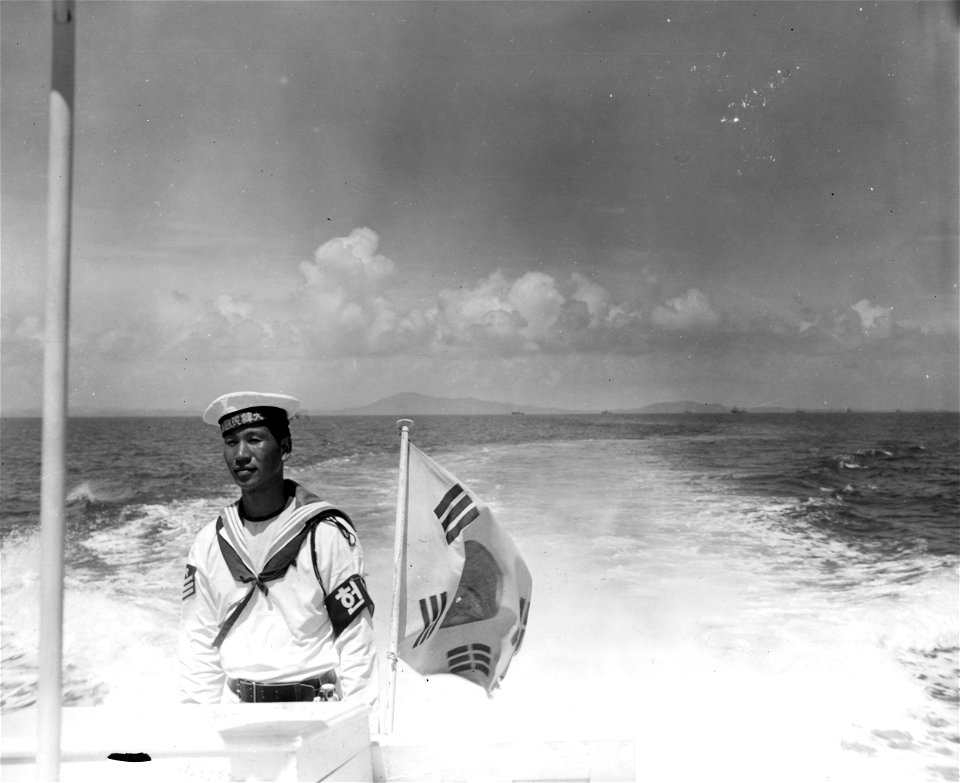 SC 334604 - A typical sailor, Korean Navy, stands aft on a launch during a demonstration of Korean Navy's strength in Inchon Harbor.
