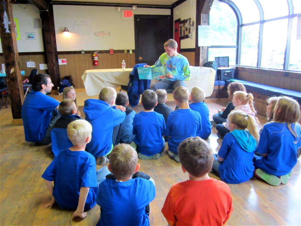 Volunteer reads to Salmon Campers
