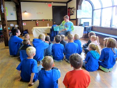 Volunteer reads to Salmon Campers