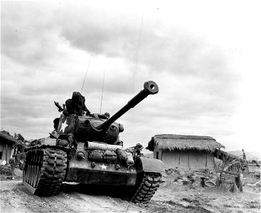 SC 348900 - General Patton M46 tank passes through village of Kumko on way to Naktong River in offensive launched against the North Korean forces in that area. 20 September, 1950.