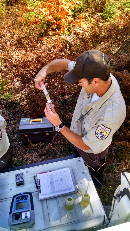Biological Science Technician Chad Andresen from the Marquette Biological Station conducts a tailgate analysis to check lampricide concentrations during treatment of the Manistique River