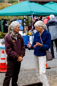 Attendees exchange words with refuge staff photo