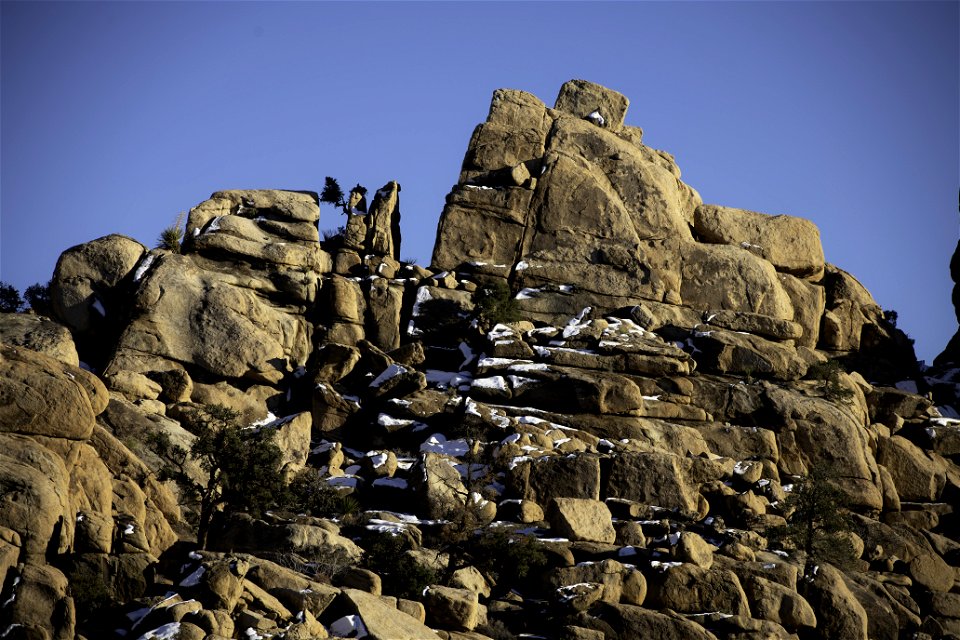 Snow over a rock formation near sunset