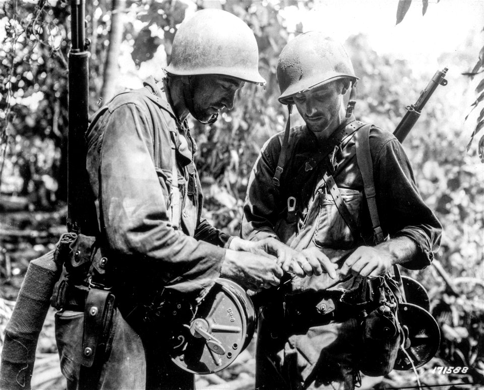 SC 171588 - At the fighting front two soldiers string wire for communications between the 127th Regiment Command Post and the 5th Portable Hospital of the 32nd Division.