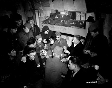 SC 405009 - Russian civilians who were German prisoners, used for slave labor, enjoy a game of cards in Hayange. 22 January, 1945.