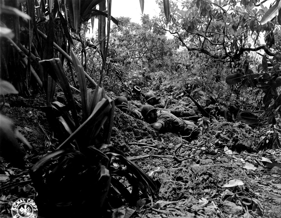 SC 374816 - Saipan. Members of an anti-straggler patrol pinned down by Jap sniper fire during the clean-up operations.