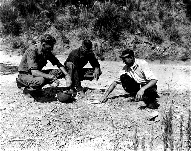 SC 180041 - Sgt. George Creswell and Lt. Charles Grant uncovering U.S. mines east of Rutino, Italy. The mines were pointed out by natives. 31 August, 1943.