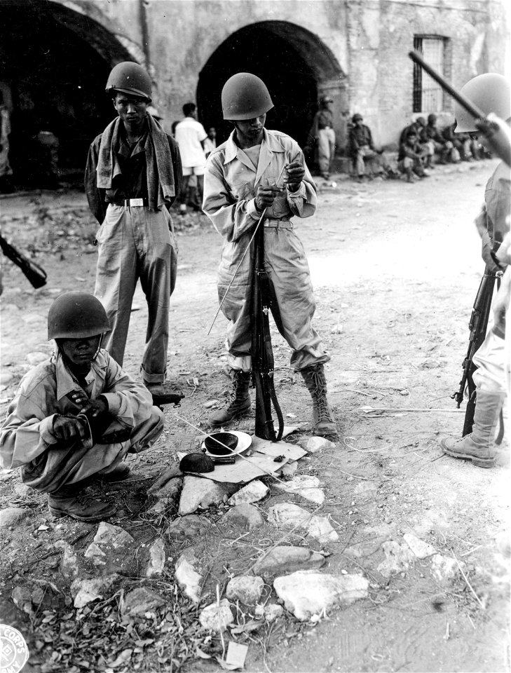 SC 364517 - Rookies of A Co., [censored] Inf., cleaning their newly issued Springfield rifles and carbines with hand-hewn bamboo cleaning rods.
