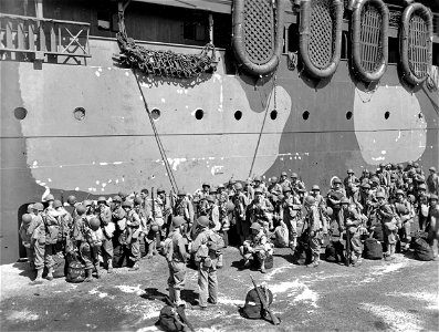SC 329693 - Troops of Co. A, 182nd Infantry, embarking on a naval transport at the Grand Quay docks, Noumea, New Caledonia. 2 November, 1942. photo