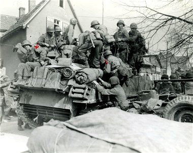 SC 270687 - 3rd U.S. Army infantrymen load onto tank destroyer in Konigstadien, Germany, as they drive deeper into Germany. 25 March, 1945. photo