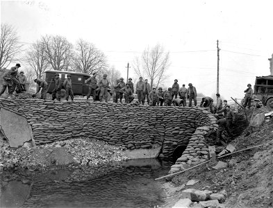 SC 337115 - 9th U.S. Army combat engineers sandbag a repaired bridge near Kamp, Germany. photo