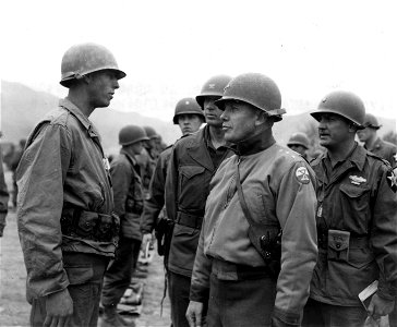 SC 364029 - Lt. Gen. Edward M. Almond, CG X Corps, stops to talk to Pfc. Joel Swanner, Jacksonville, Fla., left, Co. "F", 9th RCT., 2nd Inf. Div., during his tour of inspection of the Regt. Area.