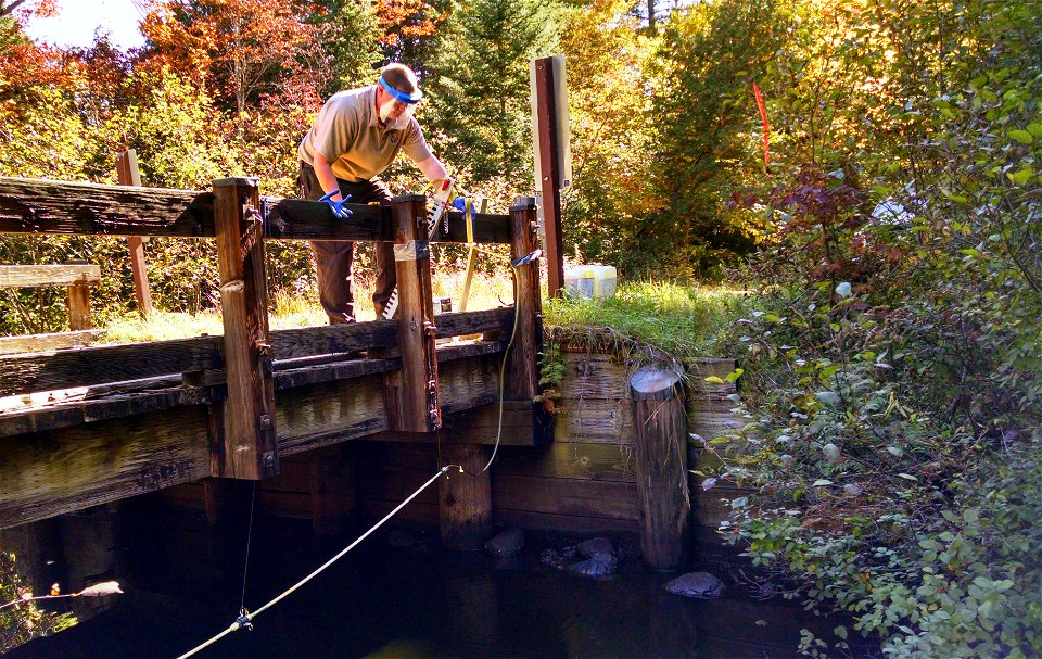 Biologist Chris Eilers from the Ludington Biological Station checks the feed rate during a lampricide application in the Manistique River