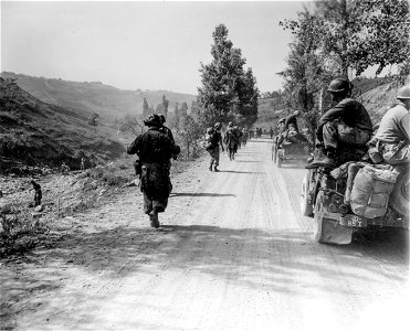 SC 270873 - Members of the 85th Regt., 10th Mtn. Div., moving up a dusty road to their new positions. photo
