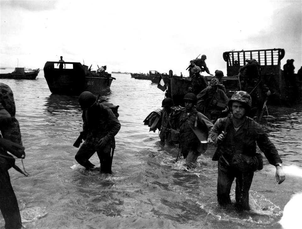 Brigadier Gen. Graves B. Erskine, Commanding General of northern landing troops and his staff, wade ashore on the island to set up a command post on D plus 2. 17 June, 1944.