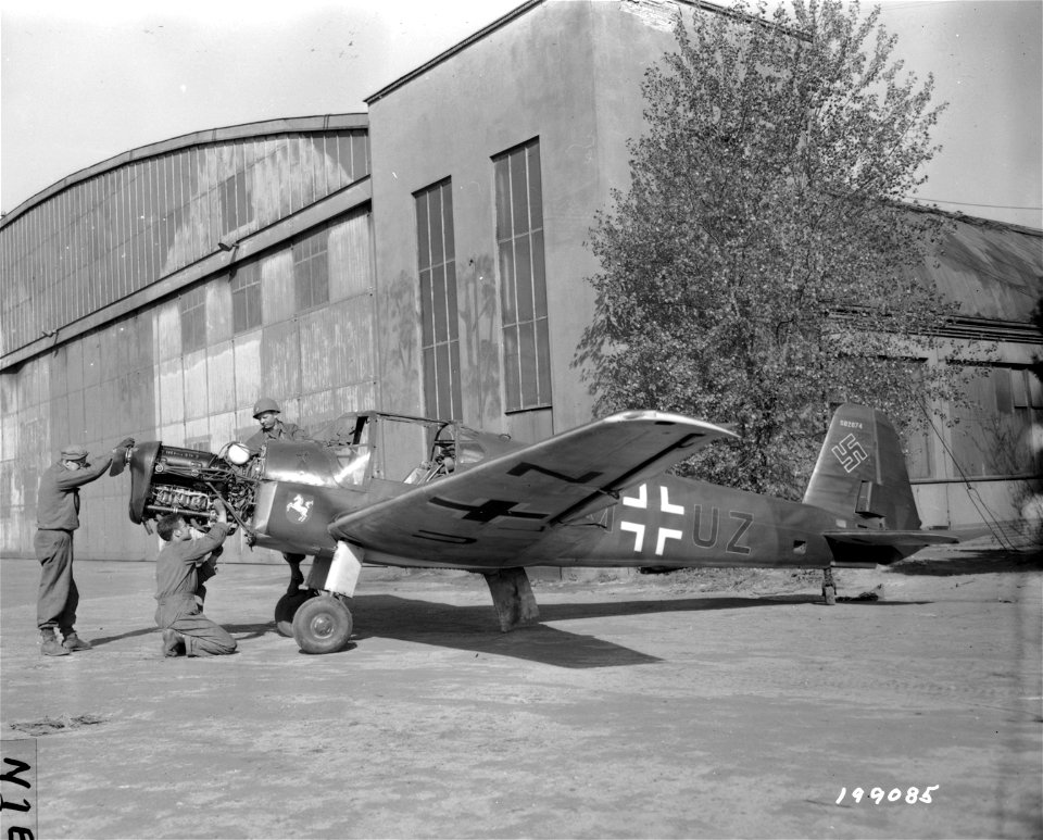 SC 199085 - Pfc. George D. Schultz, Kendall, N.Y., Pfc. Charles L. Rolbert, Collinsville, Miss., and Pfc. Regis Strahler, 419 Lockhart St., Pittsburg, Pa., of the 5th Armored Division, 9th U.S. Army, are checking a German scout plane...