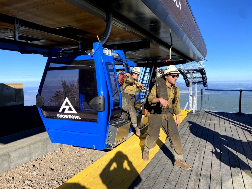 Flagstaff Hotshots depart the Arizona Gondola at the Arizona Snobowl to begin their hike into the Pipeline Fire