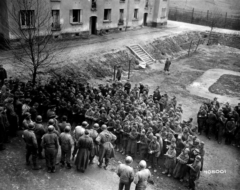 SC 405001 - Captain L. Lelikov, a Russian, addresses Russians interned in German slave labor stockade recently captured by Allies during fighting in the  Sarreguemines area.