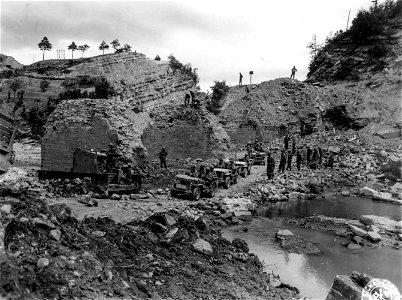 SC 195712 - 16th Engrs. construct a bypass through remains of bridge destroyed by enemy demolition five miles north of Firenzuola. 23 September, 1944.