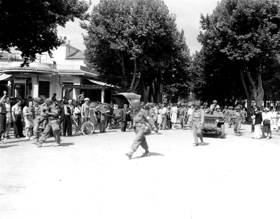 SC 270620 - Infantry marches through the main street of Aix, France. This city fell to the 3rd Div. today. 21 August, 1944.