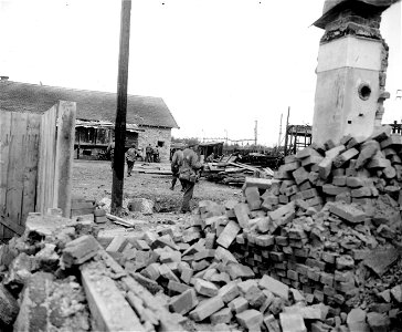 SC 270653 - Infantry of 3rd Div., first American troops in the city of Munich, move through damaged Munich railroad yards in search of Germans hiding in dugouts all through the yards and sniping at infantrymen as they pass. photo
