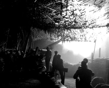 SC 364572 - Members of the 49th CA, (Colored) firing 155mm howitzer at night on Bougainville.