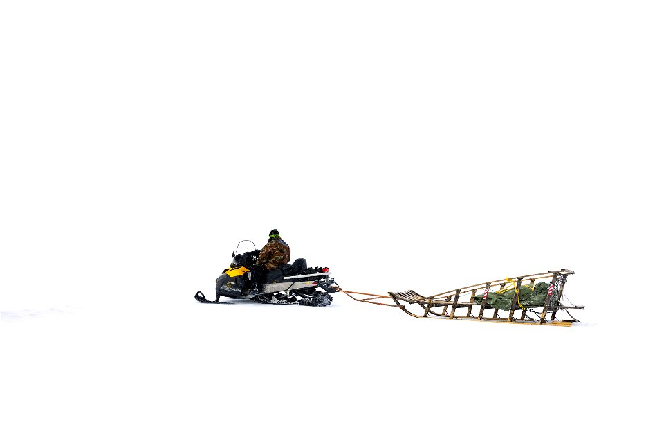 Snowmachine with basket sled.