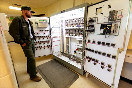 Brett Thielke, wastewater facility operator, checking timing pins photo