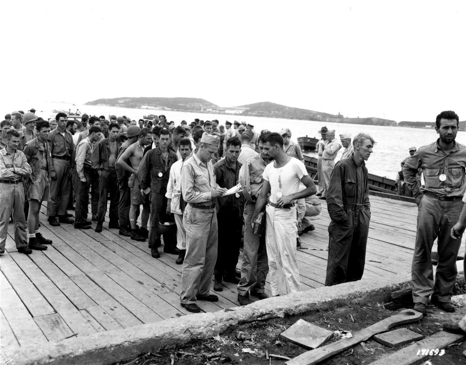 SC 171693 - First Island Command, New Caledonia. Checking names of Army casualties just returned from the Solomon Islands is Pfc. George R. Sister of Irwin, Penn. 23 January, 1943.