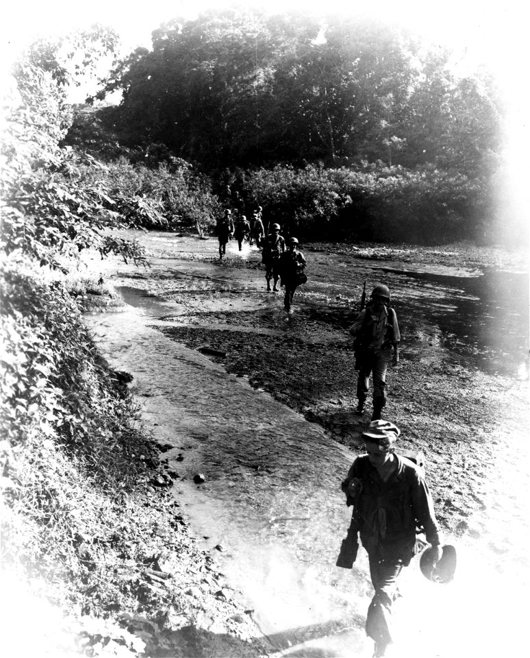 SC 270671 - Men of K Co., 186th Inf., 41st Div., cross stream while on patrol in the Sibuko Bay Area of Mindanao, P.I.