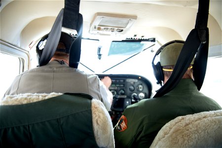 Park rangers inside NPS patrol plane photo