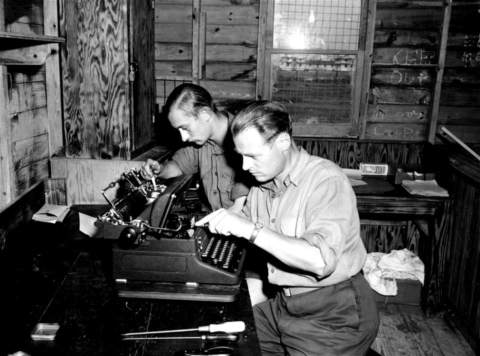 SC 184884 - Two of the German prisoners at Camp Wallace, Texas, are shown at work repairing typewriters, this being the job to which they are assigned. 1943.