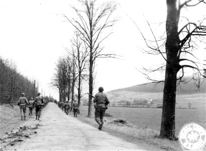 SC 270695 - Enemy resistance is encountered in the town of Adelshausen, Germany, and 6th Armored Division infantry, who usually ride with the division vehicles, are forced to enter on foot. 1 April, 1945. photo