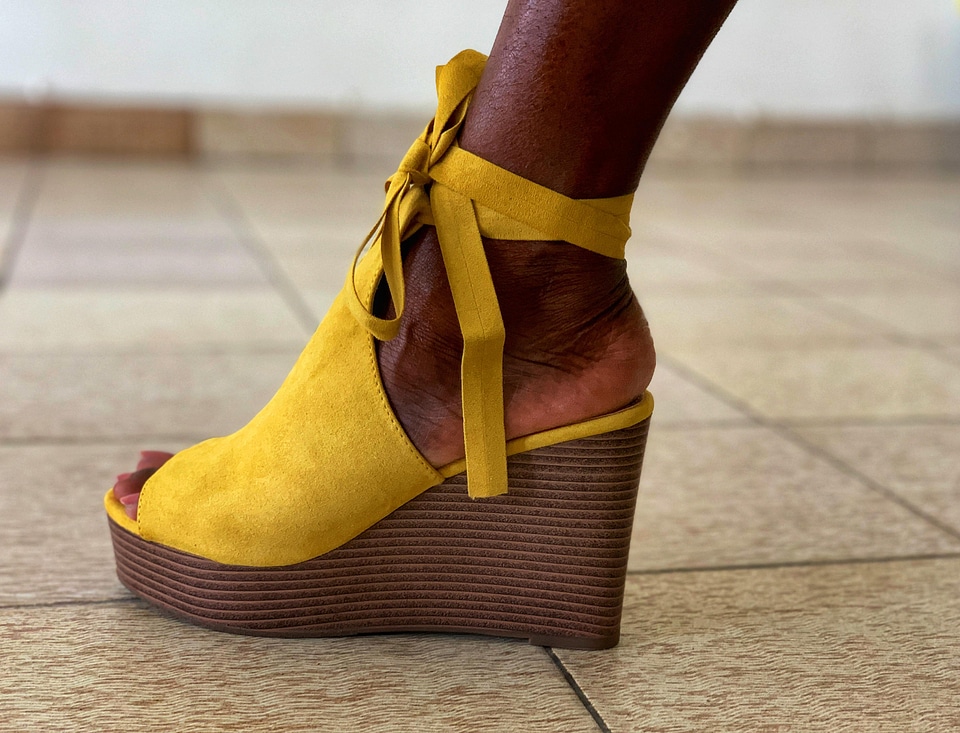 Woman foot yellow shoe