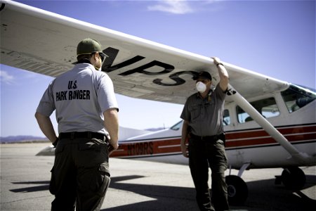 Park rangers next to NPS patrol plane photo