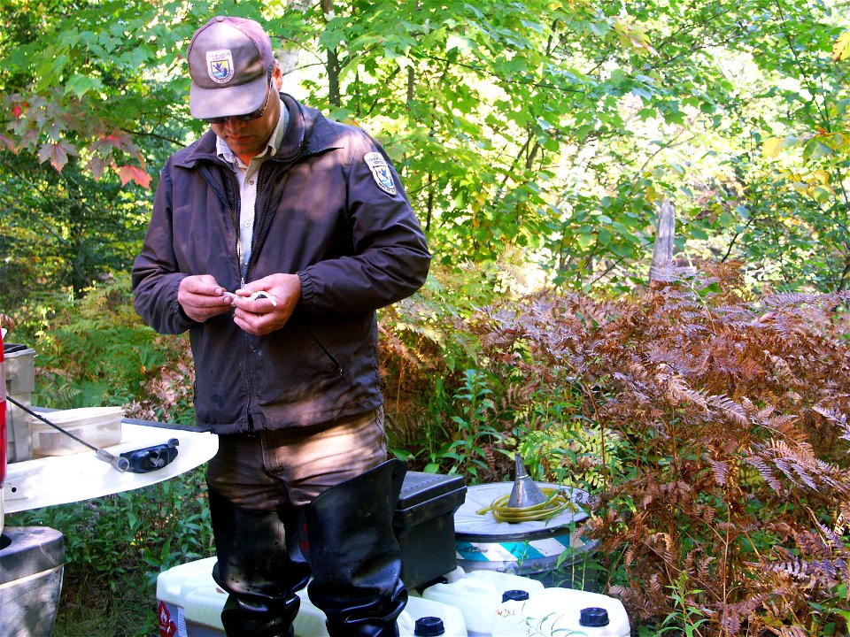 Biological Science Technician Dan Suhonen from the Marquette Biological Station prepares equipment for a  lampricde application in the Manistique River