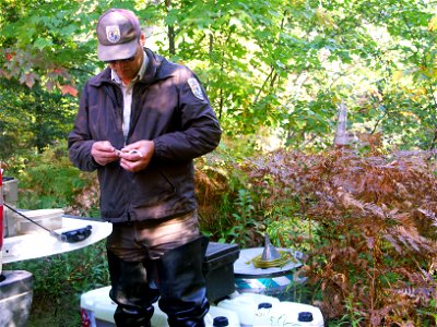 Biological Science Technician Dan Suhonen from the Marquette Biological Station prepares equipment for a lampricde application in the Manistique River photo