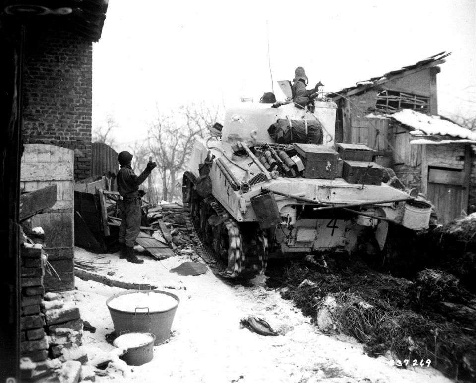SC 337269 - S/Sgt. Alva Williamson, 710 S. Monroe Ave., W. Frankfot, Ill., left, directs the tank of driver into position in Brachelen, Germany.