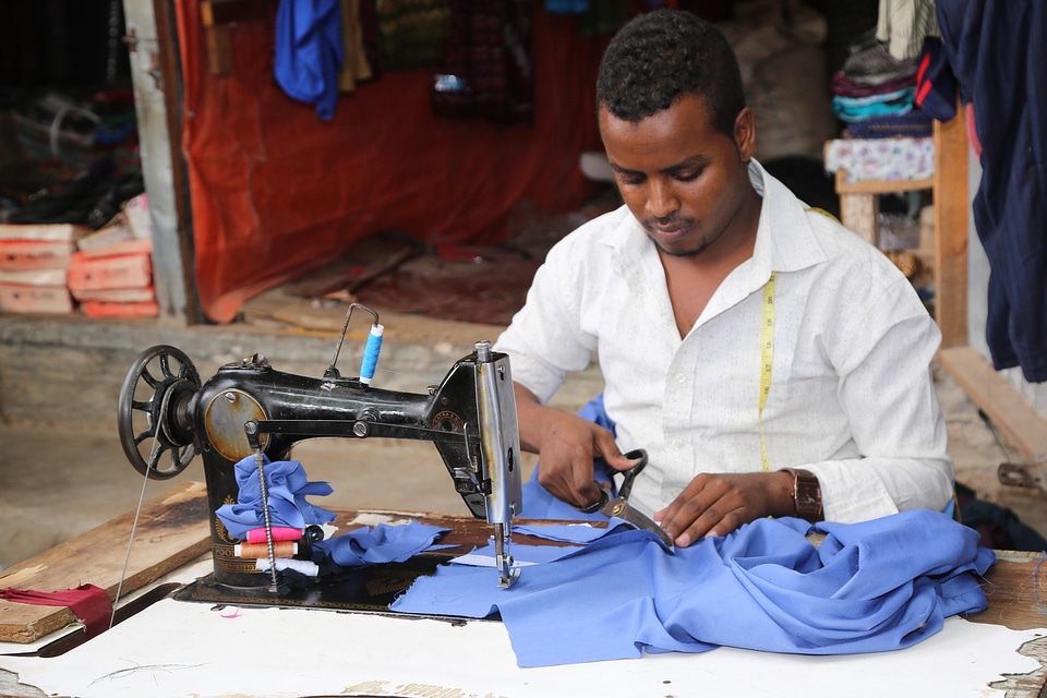 Man tailor sewing machine