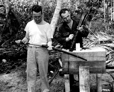 SC 107691 - Major John J. Carew examining a Japanese sword (officer's type) and Captain Emil Khail, of River, Wisc., examining a Japanese grenade thrower. photo