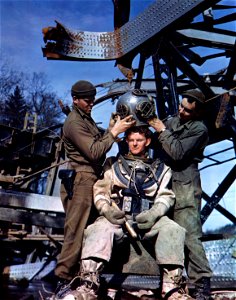 C-885 - L-R: Albert Boettner, Bronx, N.Y., assistant to diver; Michael Obrine, diver; E. L. Kennedy, Jackson, Miss., assistant to diver. photo