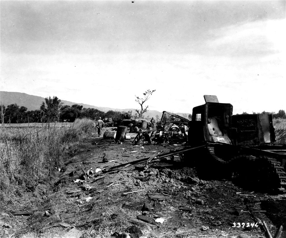 SC 337246 - The road leading to Umungan is lined with wrecked Japanese vehicles that made up a convoy of 30 trucks, 8 tanks, and 8 field pieces, destroyed by road block and field artillery of the 27th Inf. Regt.
