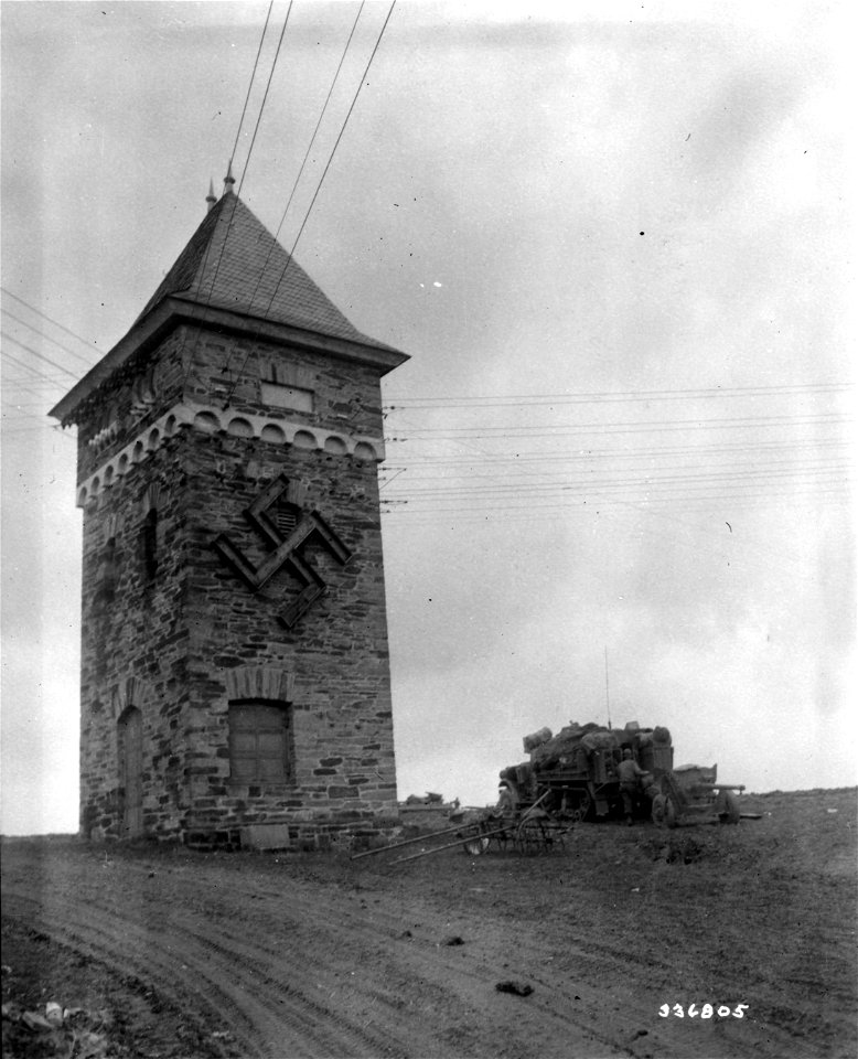 SC 336805 - The half-track of the 5th Infantry Division, U.S. Third Army, is parked near the tower outside the newly captured town. Simmern, Germany. 18 March, 1945.
