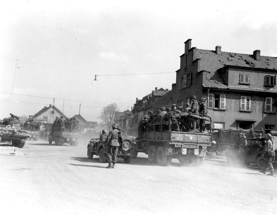 SC 335281 - Infantry moving through Homburg on the road to Kaiserslautern in trucks to regain contact with retreating enemy. 21 March, 1945.