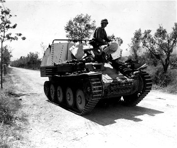 SC 329843 - Captured 75mm self-propelled being moved under own power by members of Anti-tank Co., of 85th Div., who captured it with its 9 man crew. photo