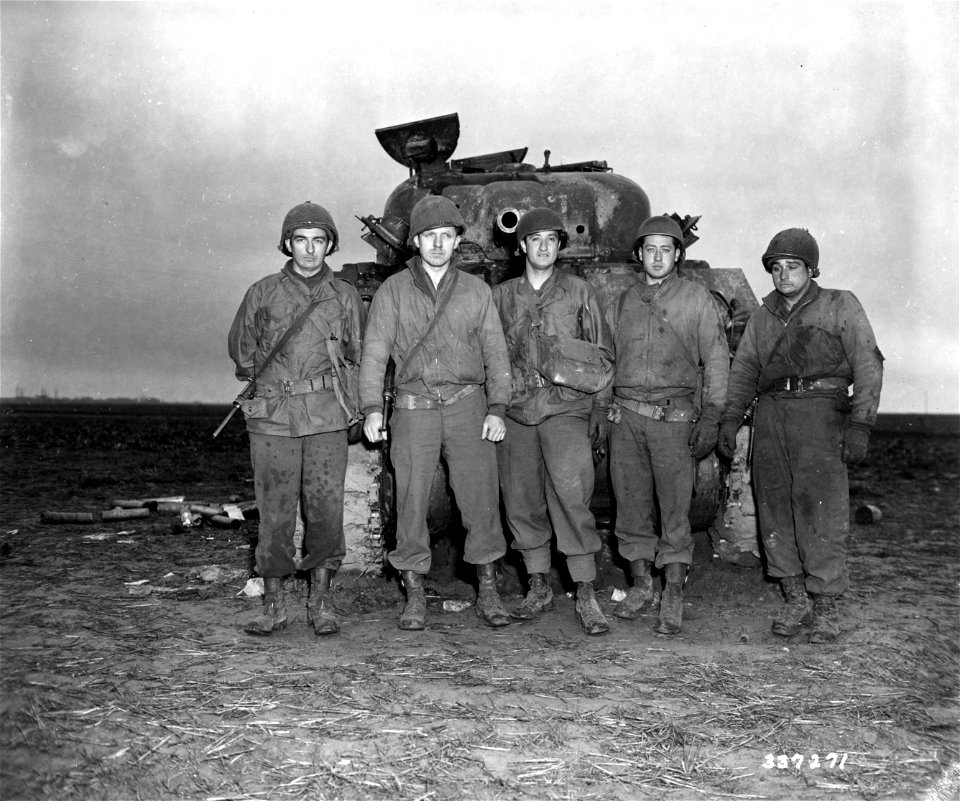 SC 337271 - The crew of the Ninth U.S. Army Sherman tank who escaped injury though their vehicle was hit by four German 88 shells in action during the capture of Hottorf, near Erkelenz, Germany.
