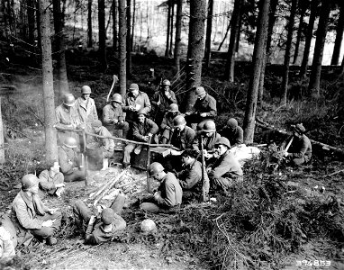 SC 396853 - Combat engineers of the 7th U.S. Army enjoying chow in pine forest in Karlsbrunn, working as lumberjacks. photo